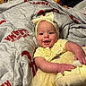 Addie joined the competition — help win amazing prizes! baby, smiling, yellow_clothing, headband, bow, blanket, alabama, infant, happy, cute, indoors, toddler, child, person, portrait, soft_texture, fabric, laying_down, cheerful, young