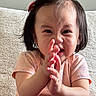 toddler, child, clapping, pink_clothing, hair_clip, short_hair, indoors, cozy, expression, face, person, cute, baby, portrait, sitting, hands, young_child, happy, home, casual