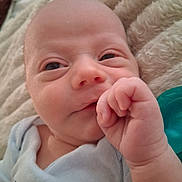 Kyler joined the competition — help win amazing prizes! baby, newborn, infant, face, hand, thumb, clothing, dinosaur_print, pacifier, blanket, soft_texture, cute, closeup, skin, expression, lying_down, indoors, child, person, sleepwear