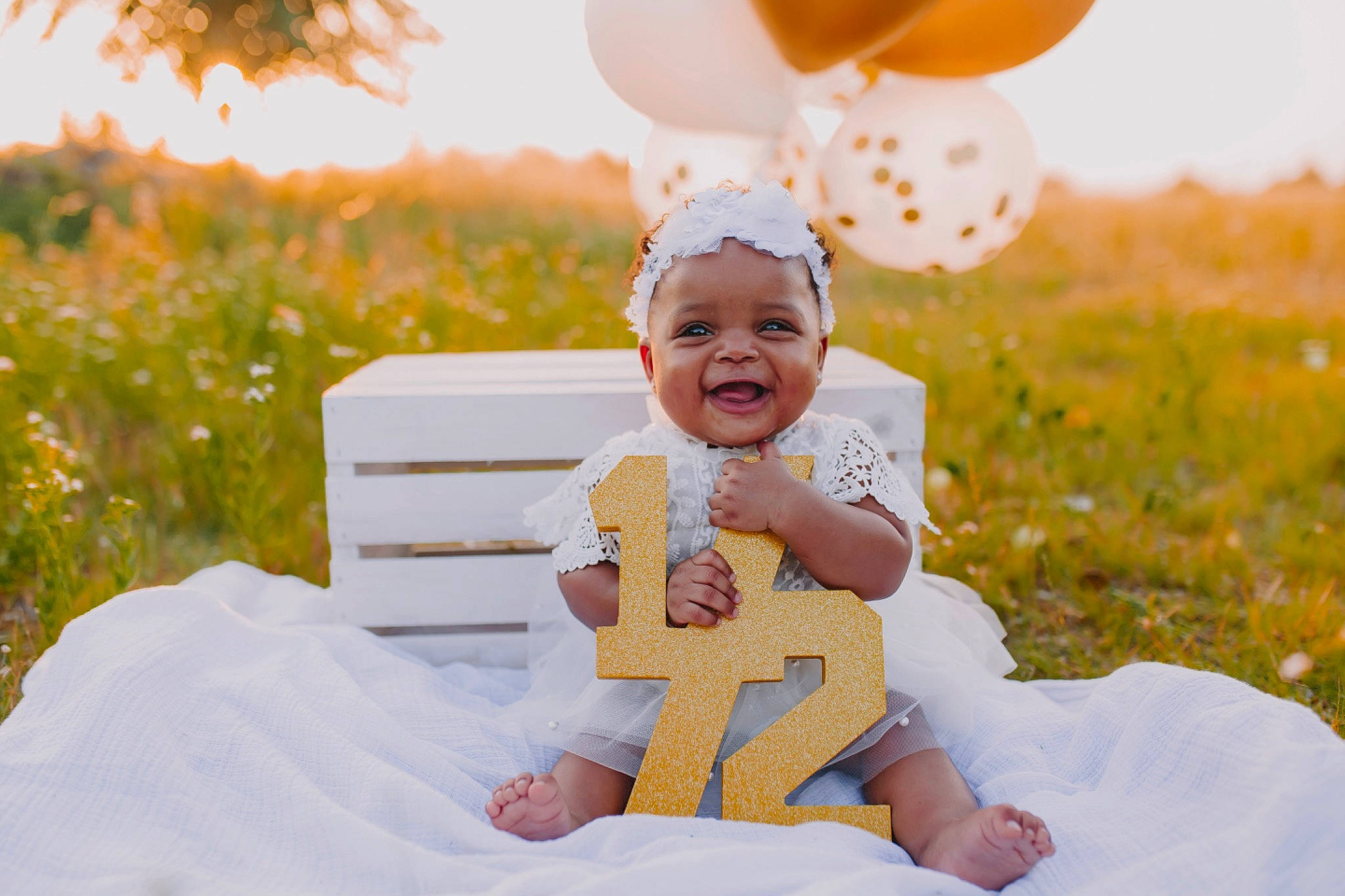 Liana is registered to the contest to win money with this photo: baby, baby_toddler_clothing, balloon, dress, facial_expression, flash_photography, fun, gesture, grass, happy, headwear, joy, light, morning, orange, people_in_nature, person, photograph, plant, smile