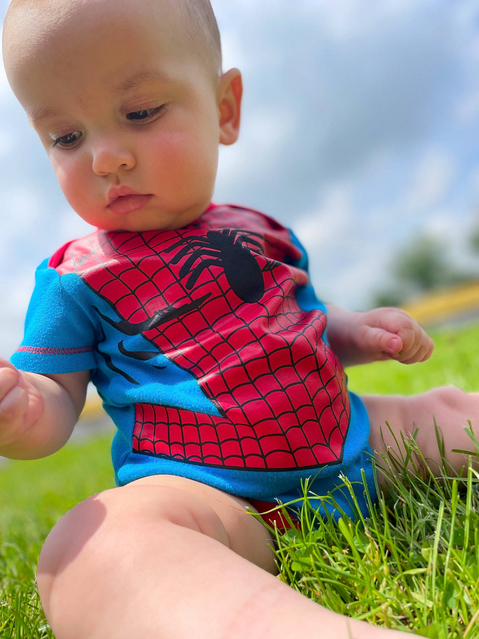 Brantley is registered to the contest to win money with this photo: azure, baby_toddler_clothing, eye, facial_expression, finger, grass, hair, hairstyle, hand, happy, head, human_body, joint, leg, people_in_nature, person, plant, red, shoulder, skin