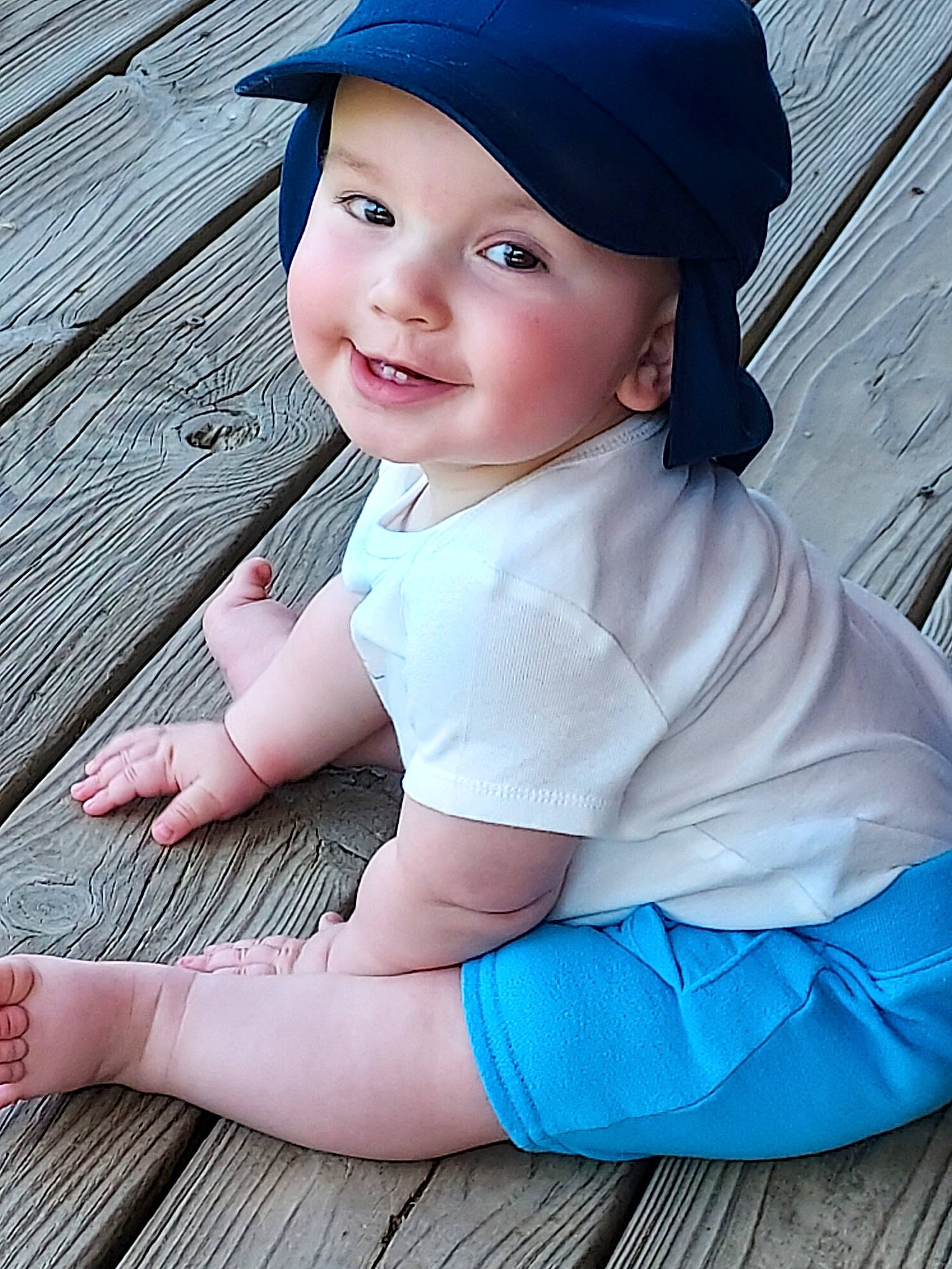 Brantley is registered to the contest to win money with this photo: baby, baby_toddler_clothing, baseball_cap, blue, cap, cheek, chin, eye, face, flash_photography, grass, hand, headwear, joy, lip, person, pink, skin, sleeve, smile