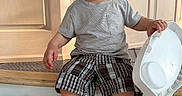 Khalid joined the competition — help win amazing prizes! baby, barefoot, carpet, chair, child, close_up, furniture, high_chair, indoor, natural_light, plaid_shorts, portrait, pouting, short_hair, sitting, striped_shirt, toddler, tray, wide_eyed, wood_paneling