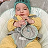 Khalid joined the competition — help win amazing prizes! baby, baby_gear, baby_hat, bouncer, child, close_up, gray_clothing, green_hat, household, indoors, infant, playroom, portrait, safe, seat, sitting, smiling, strap, toy, yellow_outfit