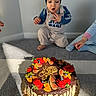 Khalid joined the competition — help win amazing prizes! child, toddler, birthday, cake, chocolate, fruit, strawberry, blueberry, fig, orange, kiwi, dessert, celebration, indoor, carpet, sitting, crouching, beanie, pajamas, smiling