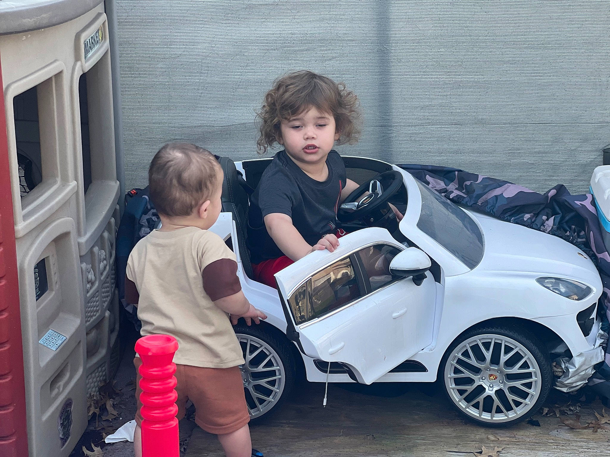 Vidal is registered to the contest to win money with this photo: alloy_wheel, auto_part, automotive_design, automotive_exterior, automotive_lighting, automotive_tire, automotive_wheel_system, bumper, car, fender, mode_of_transport, motor_vehicle, person, personal_luxury_car, rim, shorts, tire, toddler, vehicle, vehicle_door