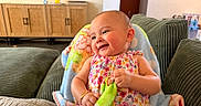 Valentina joined the competition — help win amazing prizes! apparel, baby, blanket, child, colorful, couch, cozy, cute, furniture, happy, home, indoors, infant, living_room, person, playful, portrait, seated, smiling, toddler