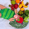 Valentina joined the competition — help win amazing prizes! apple, baby, banana, blanket, child, cute, fruit, green_clothing, infant, lemon, lettuce, lying_down, orange, outdoor, peach, pear, playful, red_hat, strawberries, vegetables