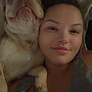 Haggerty is registered to the contest to win money with this photo: woman, dog, sleepy_dog, face, portrait, close_up, indoor, relaxed, smile, pet, companion, bed, pillow, casual, tank_top, friendship, cozy, resting, cute, animal