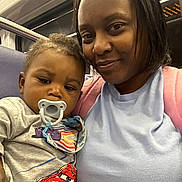 Amari joined the competition — help win amazing prizes! adult, baby, bib, car, closeup, cuddling, family, indoor, infant, mother, pacifier, portrait, public_transport, racing_car, seated, selfie, smiling, subway, train, woman