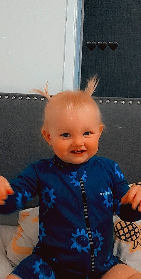 Luna is registered to the contest to win money with this photo: baby, baby_toddler_clothing, cheek, child, chin, doll, electric_blue, eye, eyelash, fun, gesture, happy, head, joy, person, room, skin, sleeve, smile, standing