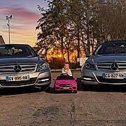 Lyana a rejoint le concours — aidez-le/la à gagner de superbes lots ! asphalt, center_composition, child, cute_child, family_scene, front_view, license_plate, luxury_car, mercedes, outdoor, parking_lot, pink_toy_car, portrait, sedan, small_driver, sunset, toddler, toy_car, trees, vehicle