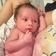 Tesssa is registered to the contest to win money with this photo: baby, newborn, infant, diaper, bed, blanket, person, skin, hand, face, lying, cute, sleeping_area, soft, toddler, young_child, indoors, resting, expression, hair