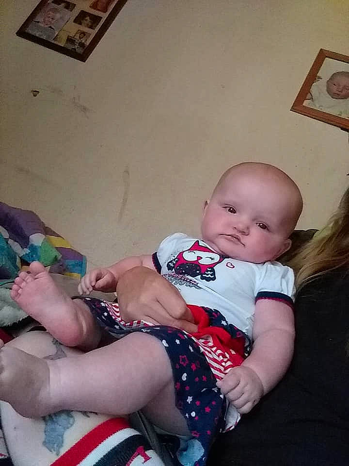 Aniyah is registered to the contest to win money with this photo: arm, baby, cheek, child, daughter, electronic_device, eye, finger, joint, lap, leg, person, sitting, skin, thumb, toddler