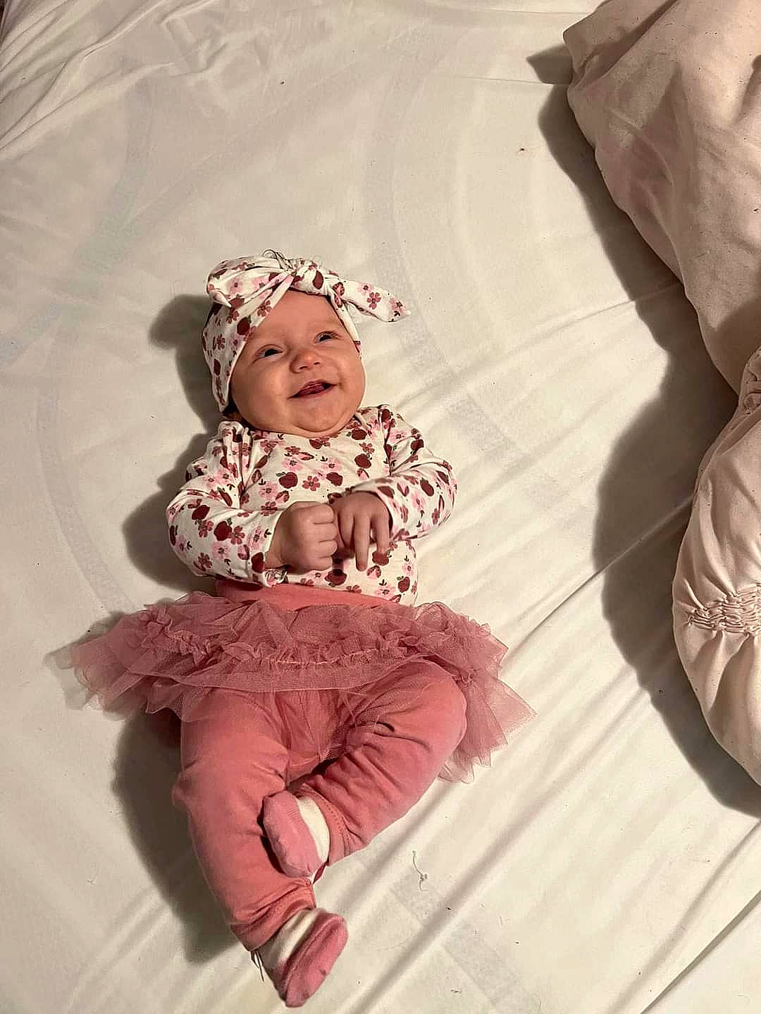 Laylah is registered to the contest to win money with this photo: baby, baby_toddler_clothing, child, comfort, costume_hat, fashion_accessory, flooring, fun, happy, headgear, headwear, magenta, pattern, peach, person, pink, sitting, skin, sleeve, textile