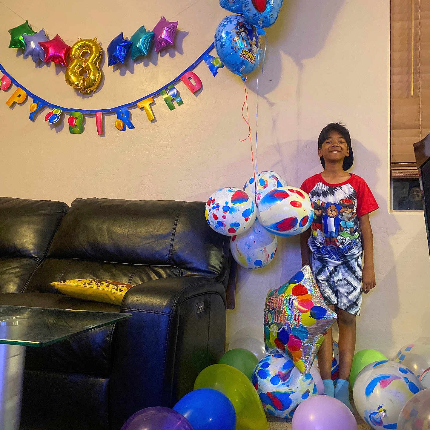 Naquan is registered to the contest to win money with this photo: accessories, architecture, balloon, boy, building, child, clothing, couch, furniture, indoors, inflatable, jewelry, livingroom, male, necklace, people, person, room, shorts, sphere