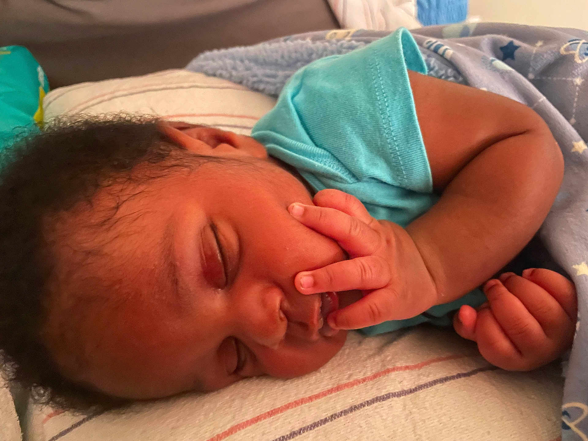 Amir joined the competition — help win amazing prizes! baby, sleeping, infant, blanket, blue_clothing, hand, face, cozy, pillow, bed, rest, peaceful, newborn, closeup, skin, cute, child, indoor, soft, relaxing