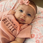 Presley is registered to the contest to win money with this photo: baby, infant, headband, bow, pink_clothing, blanket, floral_pattern, portrait, closeup, cute, face, child, soft_texture, lying_down, apparel, newborn, adorable, young_child, indoor, person