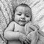 Presley is registered to the contest to win money with this photo: baby, infant, blanket, towel, smile, portrait, skin, hand, face, eyes, soft_texture, comfort, relaxation, monochrome, diaper, cuteness, newborn, expression, closeup, resting