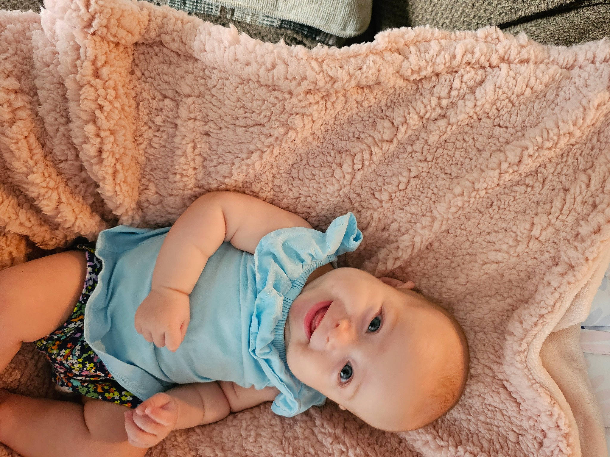 Saphira is registered to the contest to win money with this photo: arm, azure, baby, baby_products, baby_toddler_clothing, cheek, child, comfort, eye, finger, hand, headgear, human_body, joy, linens, organ, pattern, person, skin, textile