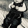Harper a rejoint le concours — aidez-le/la à gagner de superbes lots ! baby, infant, denim_overalls, socks, blanket, couch, portrait, black_and_white, hands, eyes, cheeks, tiny_hands, gaze, seated, soft_furniture, cute, clothing, closeup, bedding, relaxing