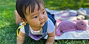Rei joined the competition — help win amazing prizes! baby, child, grass, outdoor, crawling, drool, plush_toy, blanket, sunny, greenery, cute, infant, nature, playtime, daylight, clothing, denim, skin, face, person