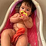 baby, bathtub, water, rubber_duck, child, skin, bath_time, toddler, toy, naked, cute, indoors, infant, pink, colorful, relaxing, sitting, small_bathtub, playful, wet