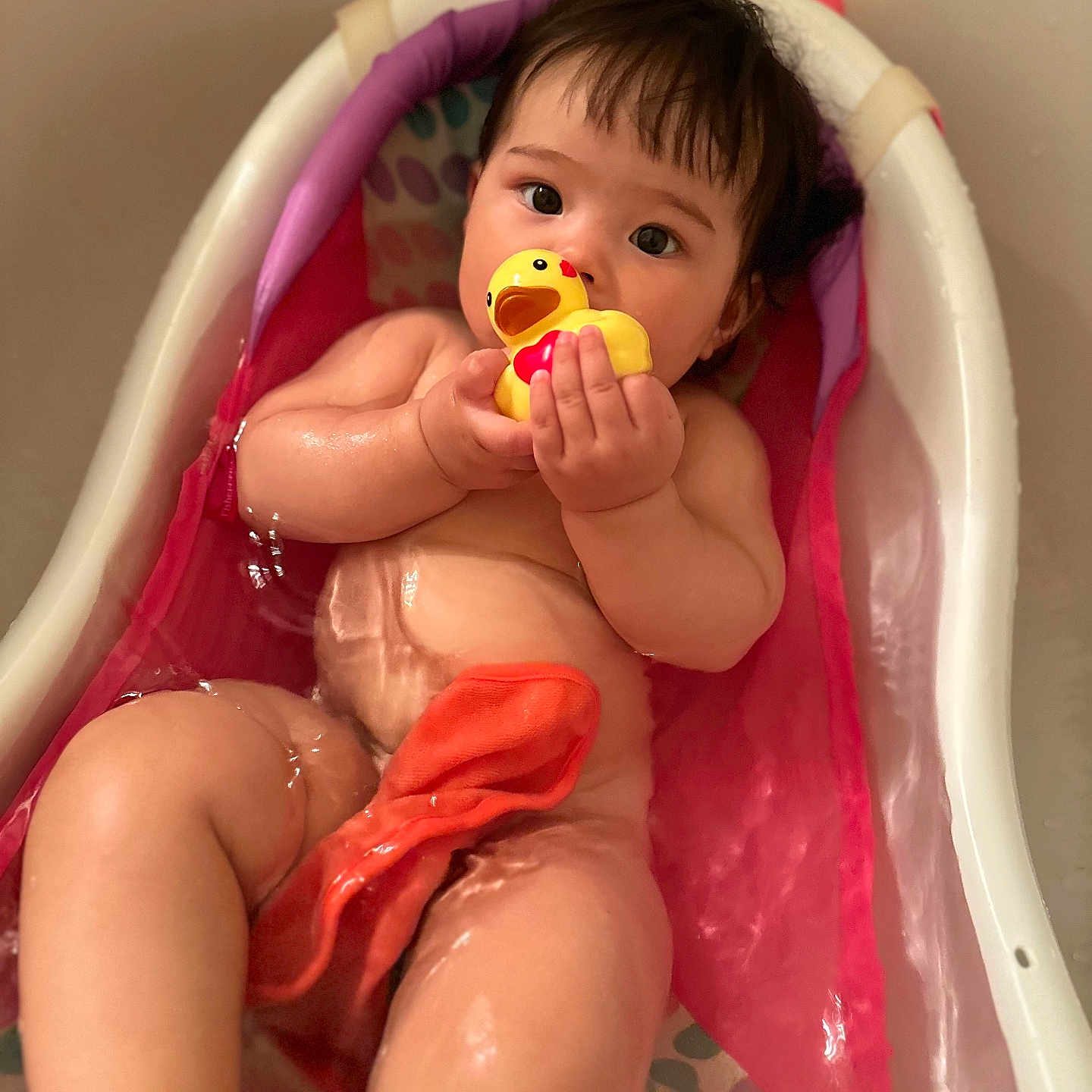 Rei is registered to the contest to win money with this photo: baby, bath_time, bathtub, child, colorful, cute, indoors, infant, naked, pink, playful, relaxing, rubber_duck, sitting, skin, small_bathtub, toddler, toy, water, wet