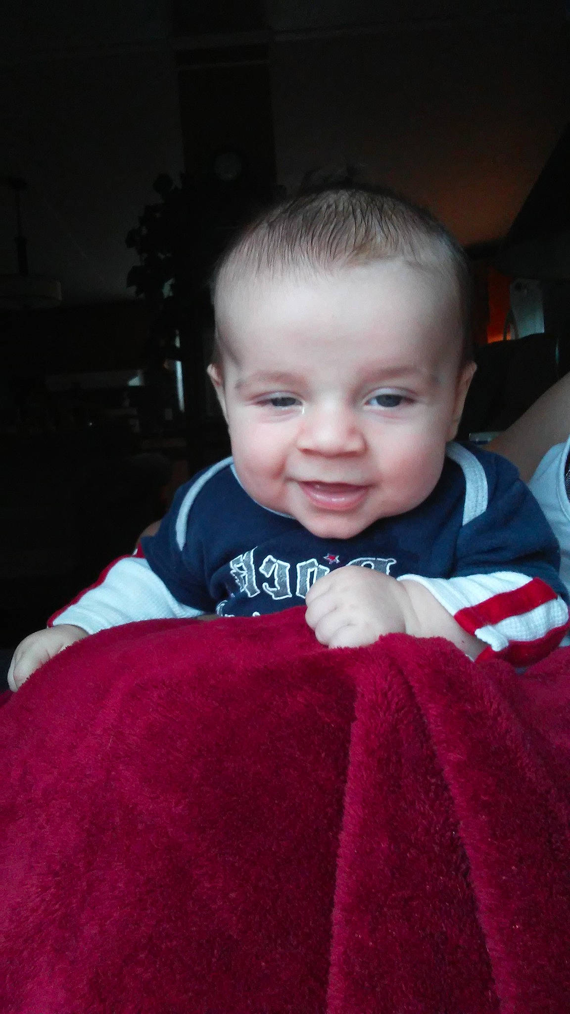 Kayden is registered to the contest to win money with this photo: baby, cheek, child, eye, face, head, lip, mouth, outerwear, person, red, skin, smile, toddler