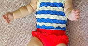 Gwen joined the competition — help win amazing prizes! arms, baby, blanket, blue, child, cute, happy, headband, indoors, infant, legs, lying_down, person, portrait, red, skin, smile, striped_clothing, textured, white