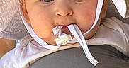 Gwen is registered to the contest to win money with this photo: baby, baby_carrier, big_eyes, chubby_cheeks, close_up, clothing, cute, fabric, face, hat_string, infant, infantino_tag, outdoor, pacifier_string, portrait, skin, straps, sun_hat, toddler, white_hat
