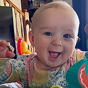 Gwen joined the competition — help win amazing prizes! baby, cheerful, child, closeup, clothing, colorful, cute, expression, face, happy, head, home, indoor, infant, person, playful, shelf, smiling, staircase, toys