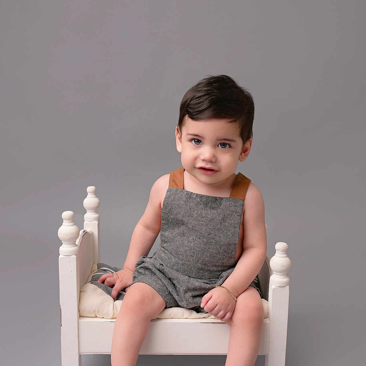 Julian is registered to the contest to win money with this photo: bodypart, boy, chair, child, clothing, crib, dress, face, finger, furniture, hand, happy, head, infantbed, male, person, photography, portrait, sitting, smile
