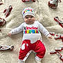 baby, infant, child, kinder_surprise, kinder_bueno, chocolate, candy, hat, onesie, socks, rug, fluffy, lying_down, cute, serious_expression, indoors, food, snack, wrapped_candy, toy_chicken