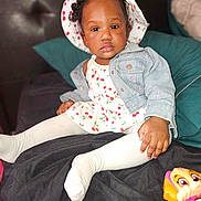Trui Love joined the competition — help win amazing prizes! baby, blanket, cherry_pattern, child, clothing, colorful, cute, denim_jacket, furniture, hat, indoor, looking_at_camera, person, playful, portrait, sitting, toddler, toy, white_tights, young_child