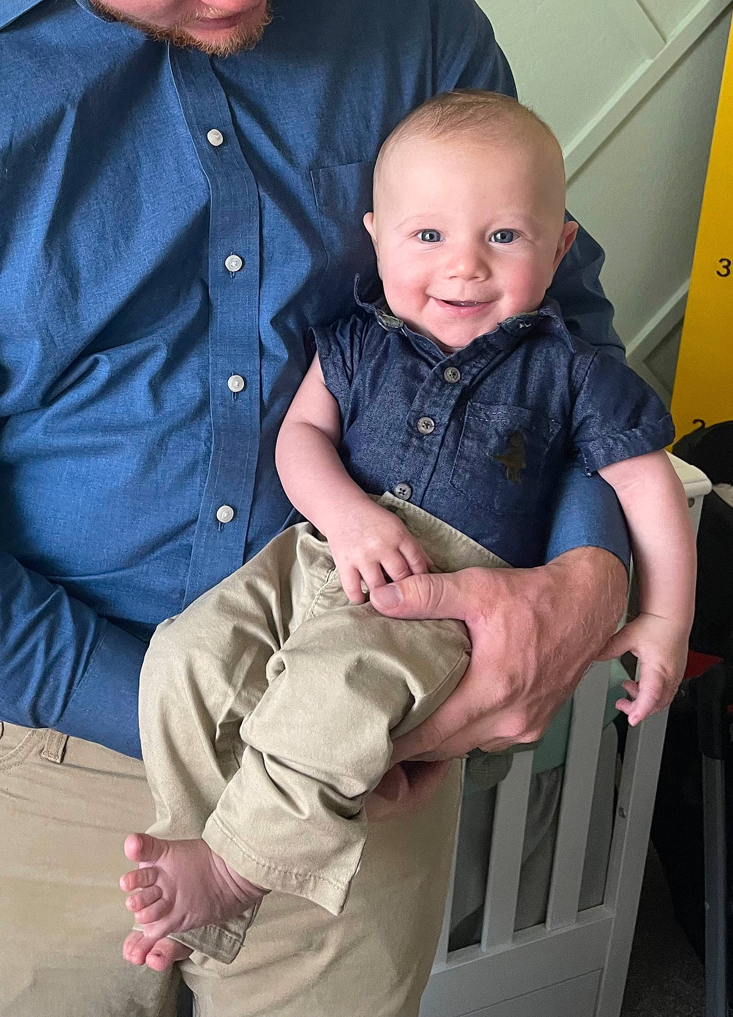 Mylo is registered to the contest to win money with this photo: baby, baby_toddler_clothing, child, collar, dress_shirt, elbow, formal_wear, fun, gesture, hand, happy, holding_hands, human_body, lap, person, shirt, sitting, sleeve, smile, thumb
