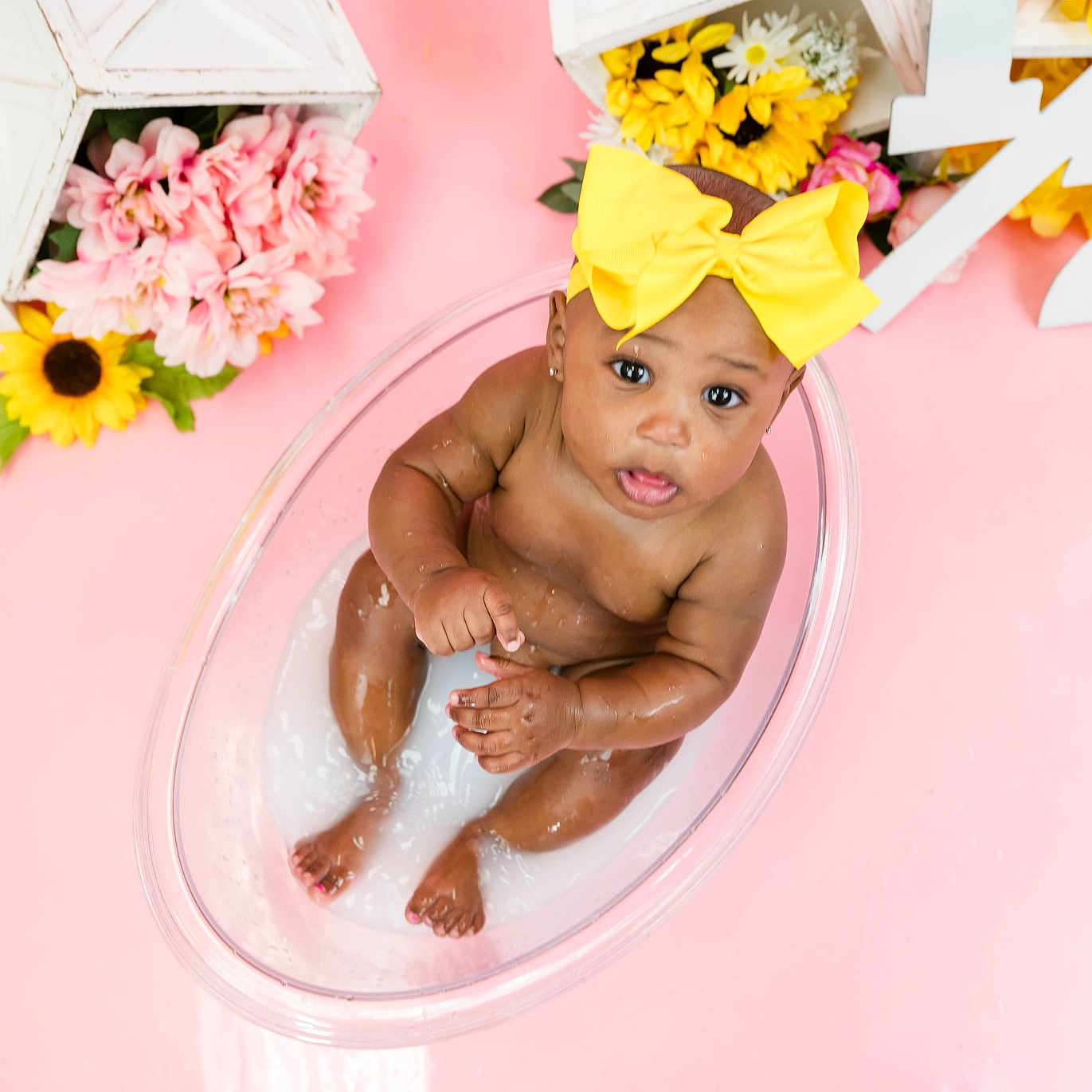 Aubree joined the competition — help win amazing prizes! baby, bathing, bathtub, cap, clothing, daisy, face, flower, flowerarrangement, flowerbouquet, hat, head, indoors, person, petal, photography, plant, portrait, pottedplant, tub