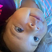Reign joined the competition — help win amazing prizes! baby, face, infant, closeup, pacifier, striped_clothing, lying_down, purple_clothing, pink_letters, skin, eye, mouth, nose, head, child, person, young, indoors, soft_light, portrait