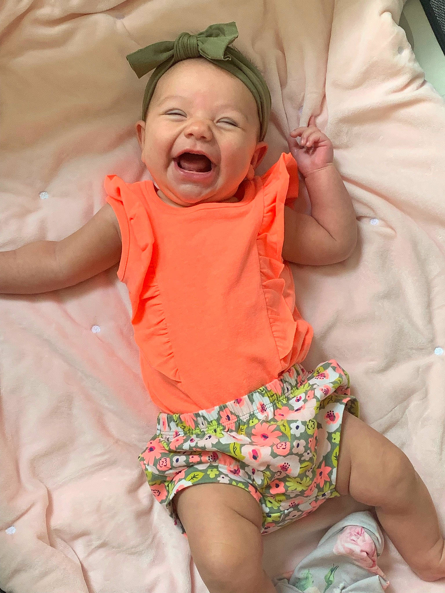 Harlowe joined the competition — help win amazing prizes! arm, baby, baby_toddler_clothing, comfort, eye, face, facial_expression, finger, green, happy, head, human_body, mouth, orange, person, pink, skin, sleeve, smile, textile