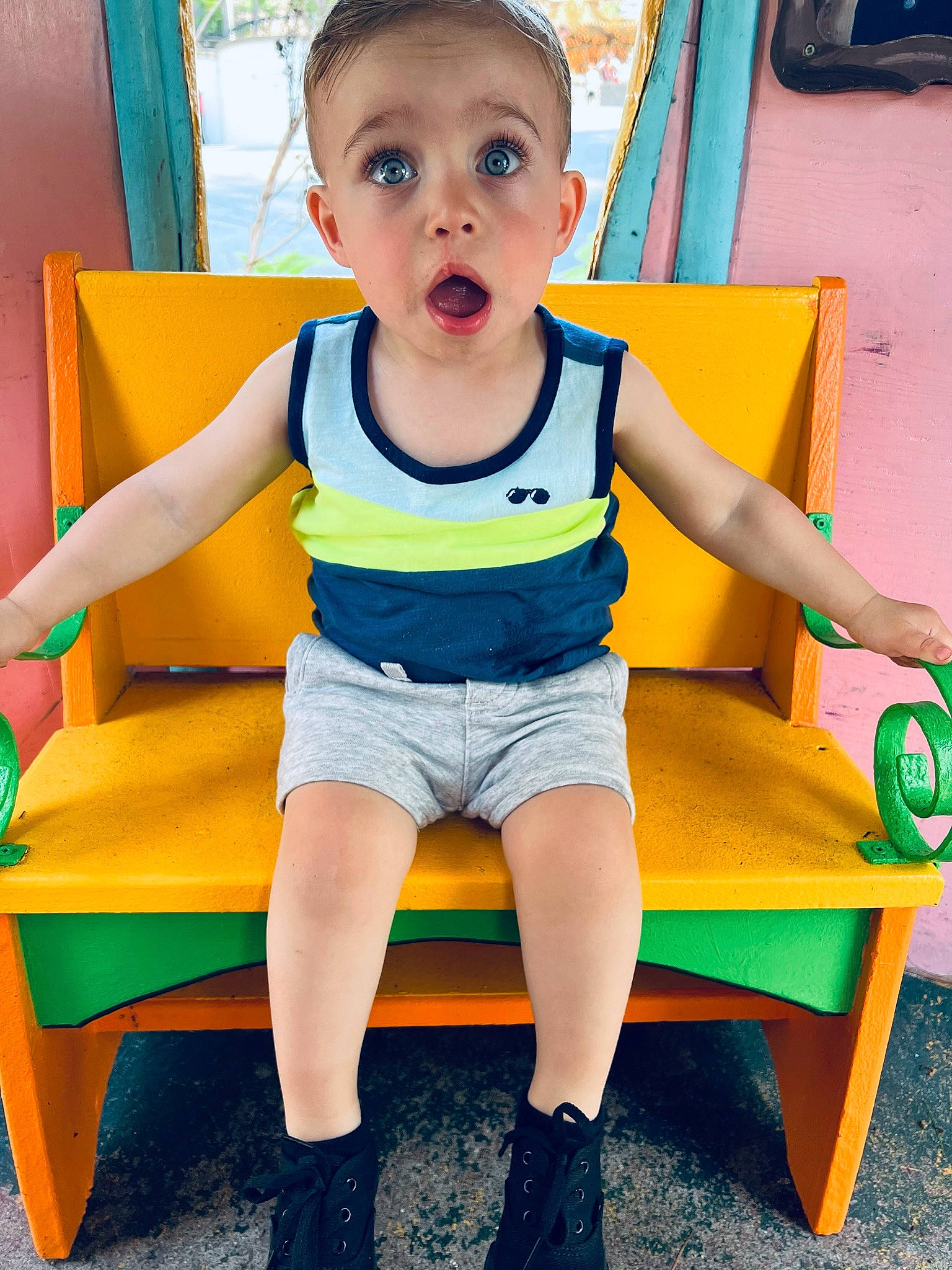 Kylen is registered to the contest to win money with this photo: baby_toddler_clothing, blue, child, city, electric_blue, fun, green, happy, human_leg, leisure, outdoor_play_equipment, person, playground, recreation, shorts, snapshot, standing, summer, surprise, thigh