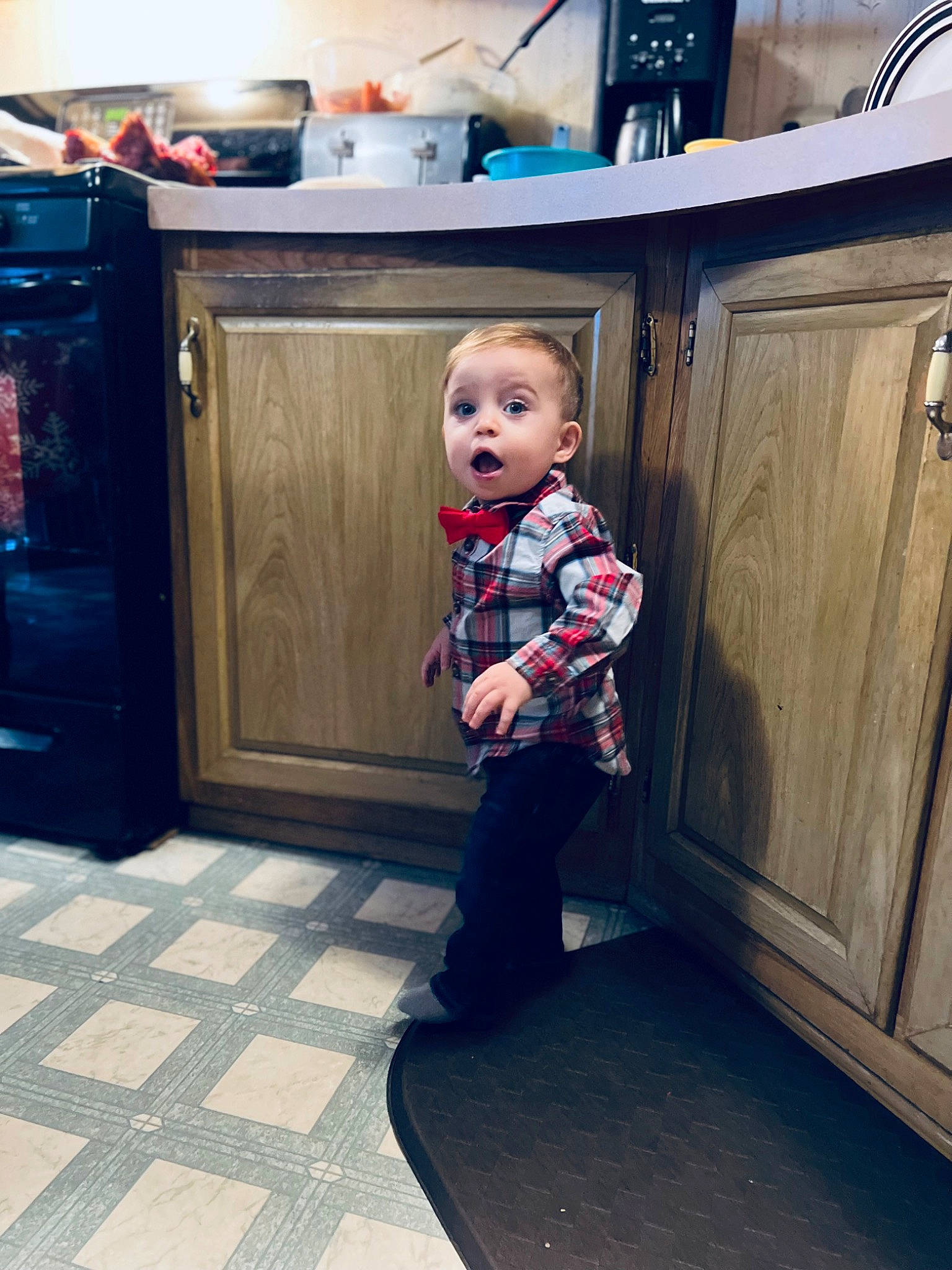 Kylen is registered to the contest to win money with this photo: baby_toddler_clothing, blue, cabinetry, child, cupboard, door, electric_blue, floor, flooring, fun, hardwood, home_appliance, kitchen, kitchen_appliance, person, refrigerator, room, sleeve, standing, surprise