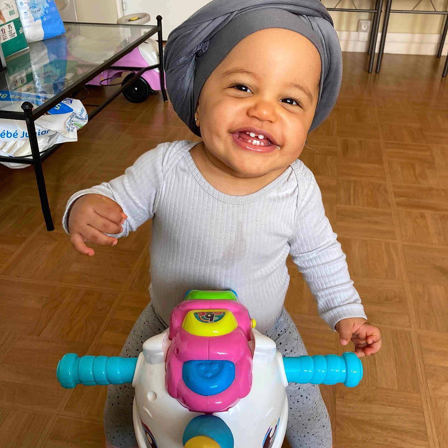 Mellya participe au concours pour gagner de l'argent avec cette photo : architecture, baby, building, clothing, face, furniture, happy, hat, head, helmet, indoors, livingroom, person, photography, portrait, room, sitting, smile, table, wood