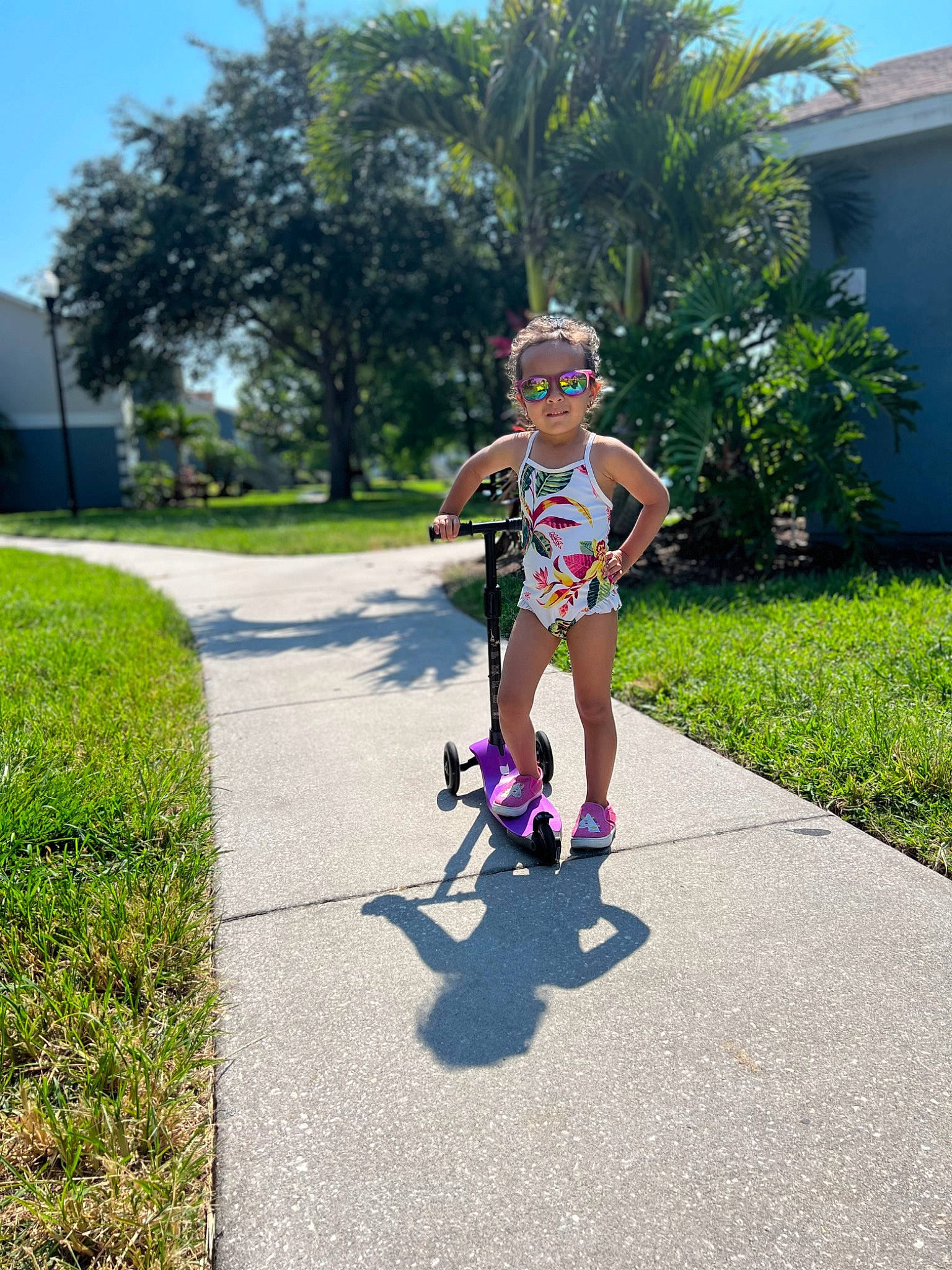 Janessa is registered to the contest to win money with this photo: asphalt, baby, child, dress, electric_blue, fun, garden, grass, happy, landscape, leisure, palm_tree, person, plant, recreation, road, road_surface, sidewalk, sky, toddler