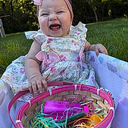 Sophie joined the competition — help win amazing prizes! baby, bow, child, cute, dress, easter_basket, face, floral, girl, grass, grass_background, hand, happy, headband, outdoor, pink, plastic_eggs, playpen, sitting, smiling