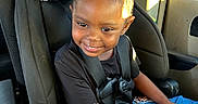 Miracle is registered to the contest to win money with this photo: braided_hair, car_interior, car_seat, child, clothing, daylight, girl, graco, happy, portrait, purple_bow, seatbelt, sitting, smile, sunlight, tablet, technology, vehicle, window, young_child
