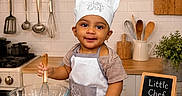 Riyank joined the competition — help win amazing prizes! apron, baby, baking, chef_hat, child, chocolate_chips, cookie_cutters, cooking, countertop, cutting_boards, eggs, flour, kitchen, plants, portrait, rolling_pin, smiling, stove, whisk, wooden_spoons
