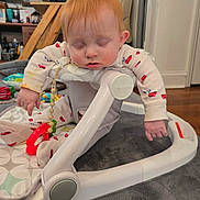 Cassius joined the competition — help win amazing prizes! baby, baby_seat, cute, face, furniture, hand, hardwood_floor, indoor, infant, living_room, onesie, pajamas, playmat, portrait, redhead, sleeping, teether, television, tired, toy