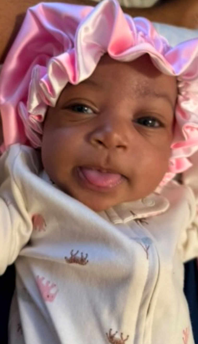 Xiori joined the competition — help win amazing prizes! baby, infant, face, pink_bonnet, clothing, onesie, tongue_out, cute, close_up, child, headwear, sleepwear, smiling, portrait, skin, young_child, baby_girl, expression, adorable, playful