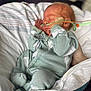 newborn, baby, infant, sleeping, onesie, green_clothing, hospital, nasal_tube, medical_equipment, blanket, bed, hand, soft, cozy, peaceful, cute, toddler, healthcare, resting, portrait