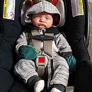 Elijah joined the competition — help win amazing prizes! baby, car_seat, onesie, reindeer_hood, antlers, mittens, socks, sleepy, child, infant, straps, black, gray_clothing, cute, indoors, seatbelt, toddler, expression, wearing_hood, resting
